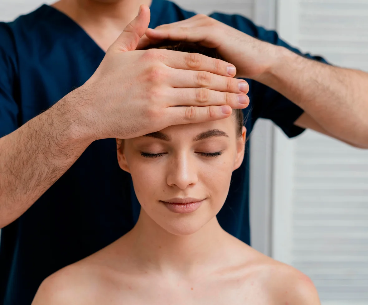 Person receiving a head massage therapy session.