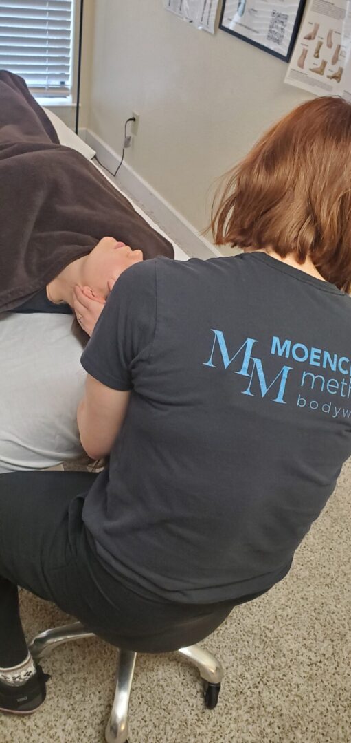 Moench Method therapist working on a client's neck.